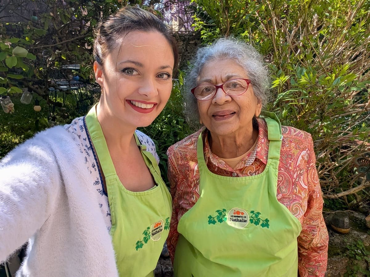 Photo of an immersion student taking cooking class with her French teacher, Eliane 